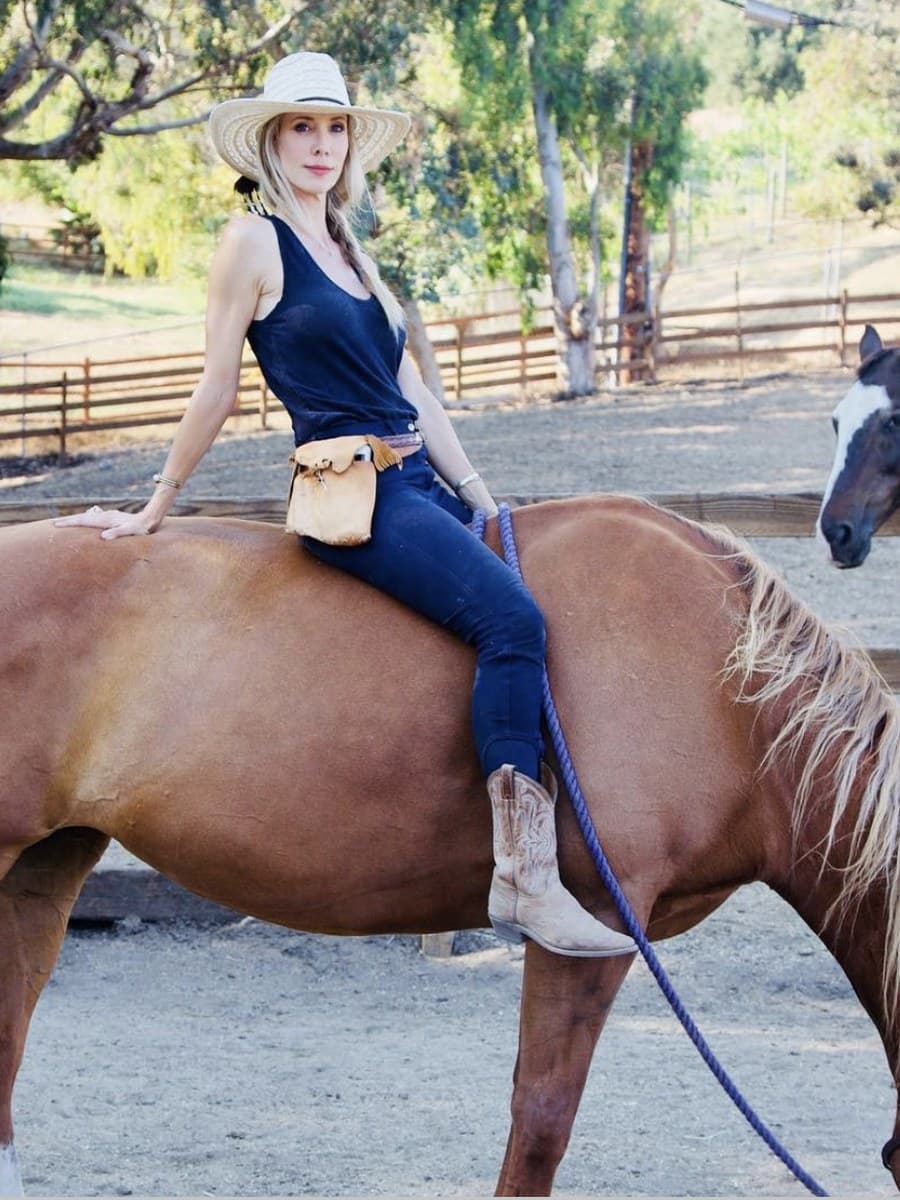 Rose Mary Riggs on Sophie in the paddock, the mare grazing under her